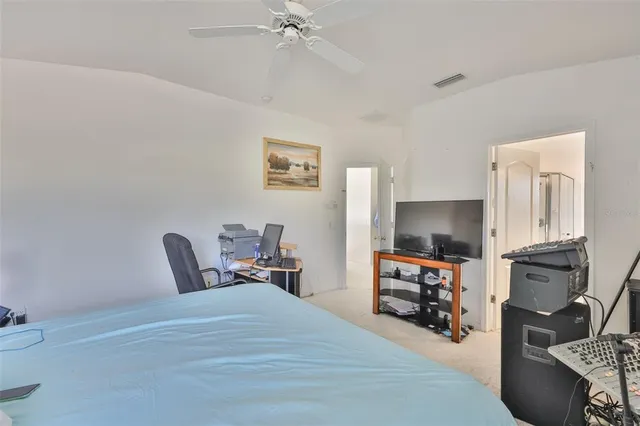 a bedroom with furniture and a flat screen tv