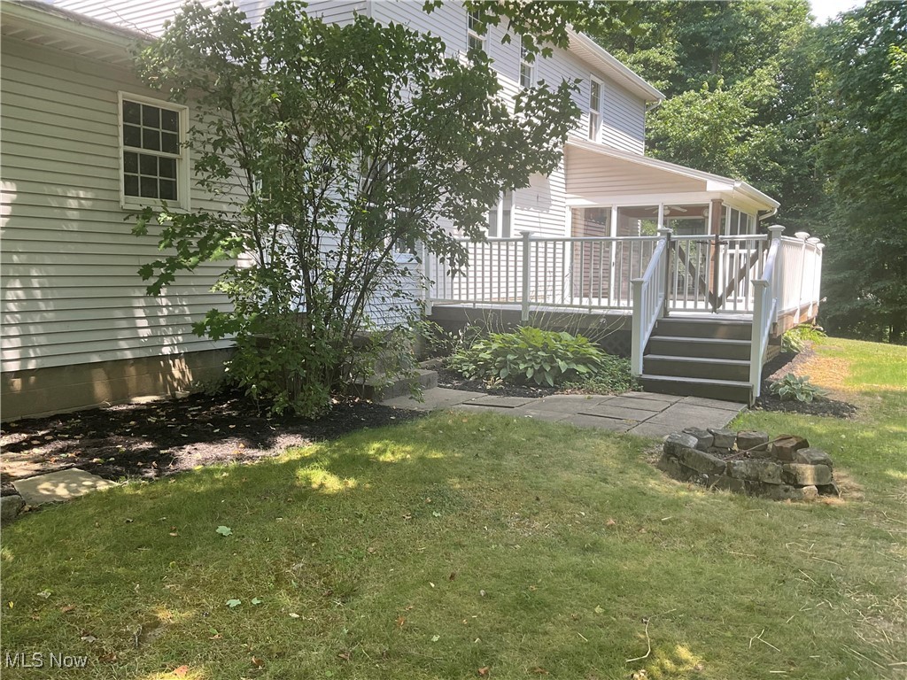 7345 Roller Road Salem, OH 44460 - Photo 35 of 50 View of green lawn featuring a sunroom, a deck, and stairway