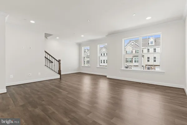 a kitchen with stainless steel appliances granite countertop a sink a stove a refrigerator cabinets and wooden floor