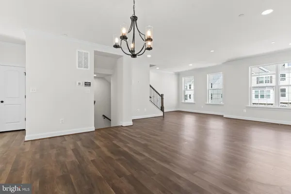 a view of a kitchen with wooden floor and a sink