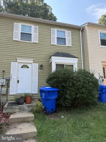 a view of a backyard with plants and a patio