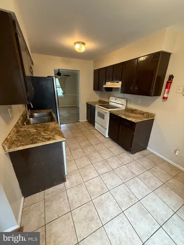 a kitchen with stainless steel appliances kitchen island granite countertop a sink and a stove