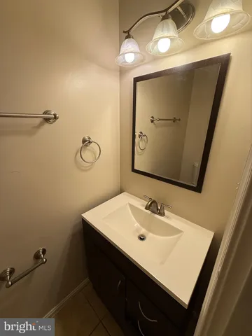 a bathroom with a sink vanity and a mirror