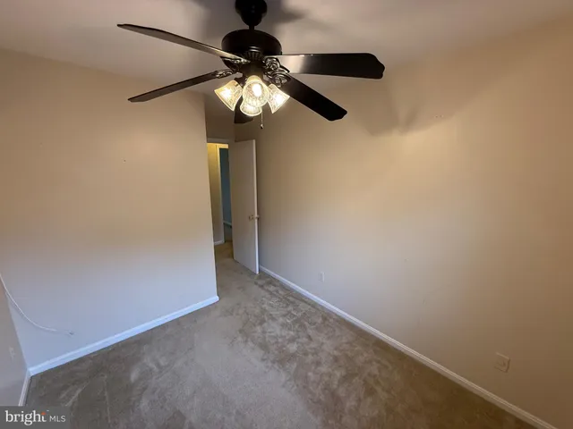a view of a hallway with a chandelier fan