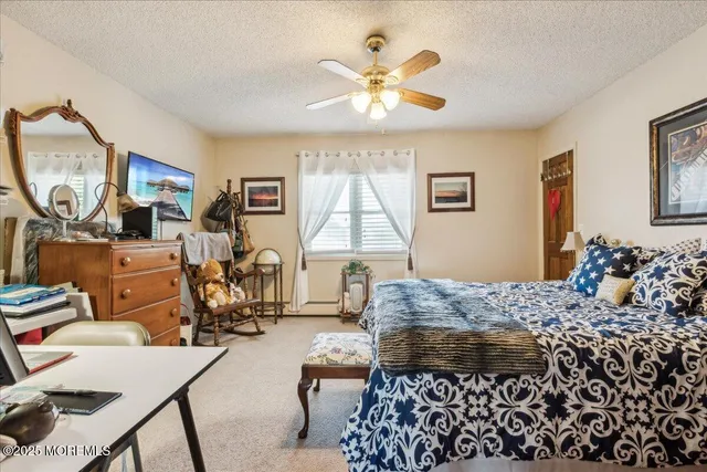 a bed room with a bed mirror and a window