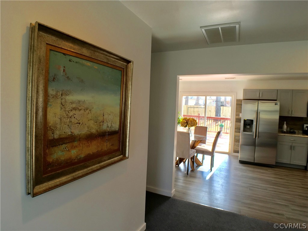 14100 South Hackberry Road Chester, VA 23836 - Photo 11 of 42 a view of a living room and dining room with wooden floor
