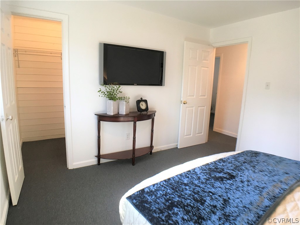 14100 South Hackberry Road Chester, VA 23836 - Photo 14 of 42 a bedroom with a bed and a flat screen tv