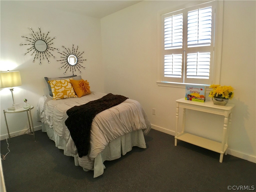 14100 South Hackberry Road Chester, VA 23836 - Photo 15 of 42 a bed sitting in a bedroom next to a window