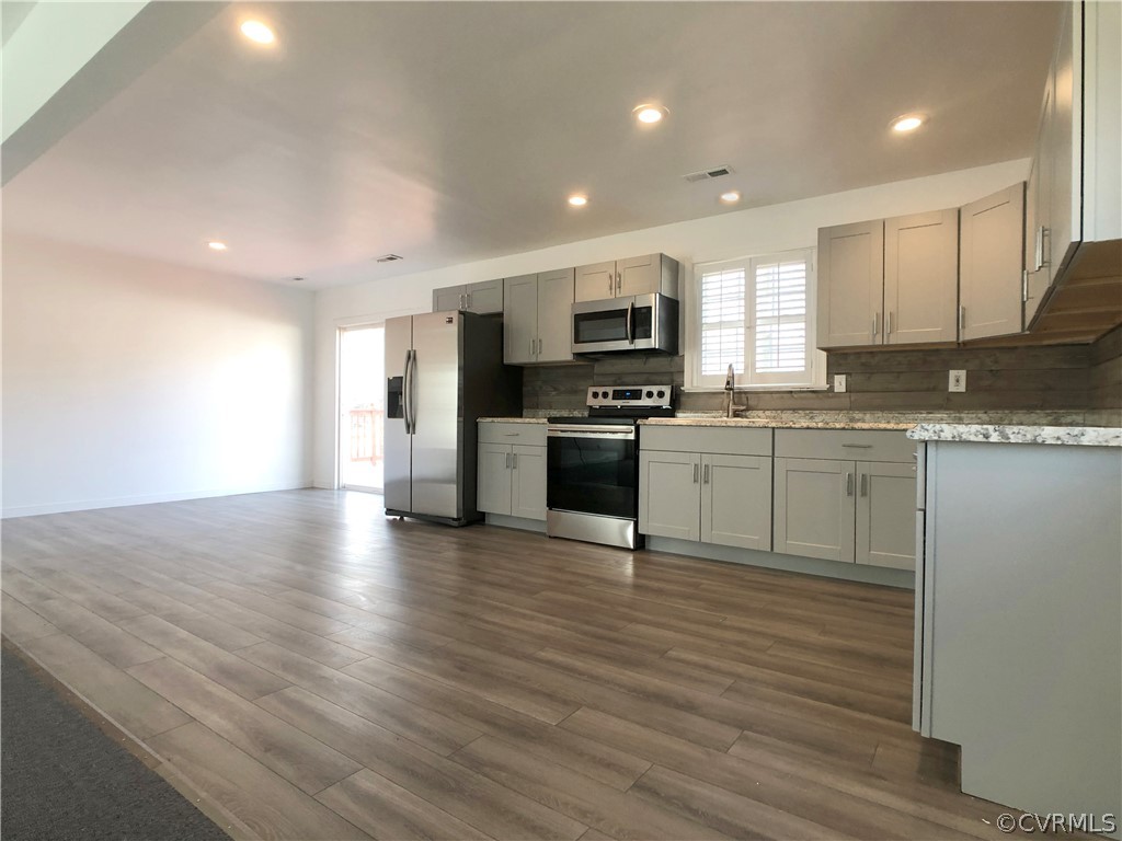 14100 South Hackberry Road Chester, VA 23836 - Photo 20 of 42 a kitchen with stainless steel appliances granite countertop a sink a stove top oven a counter space and cabinets