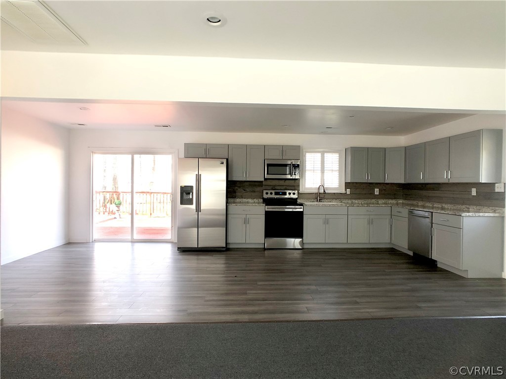 14100 South Hackberry Road Chester, VA 23836 - Photo 24 of 42 a kitchen with stainless steel appliances granite countertop a stove top oven and sink