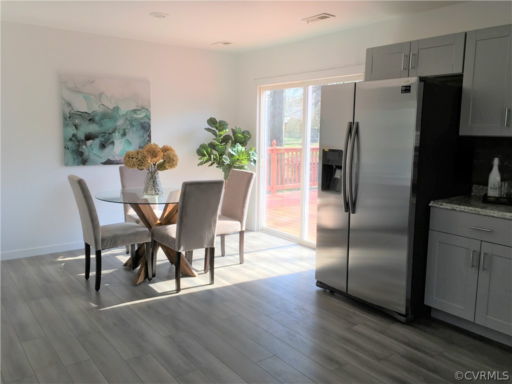 14100 South Hackberry Road Chester, VA 23836 - Photo 4 of 42 a view of a dining room with furniture a refrigerator and wooden floor