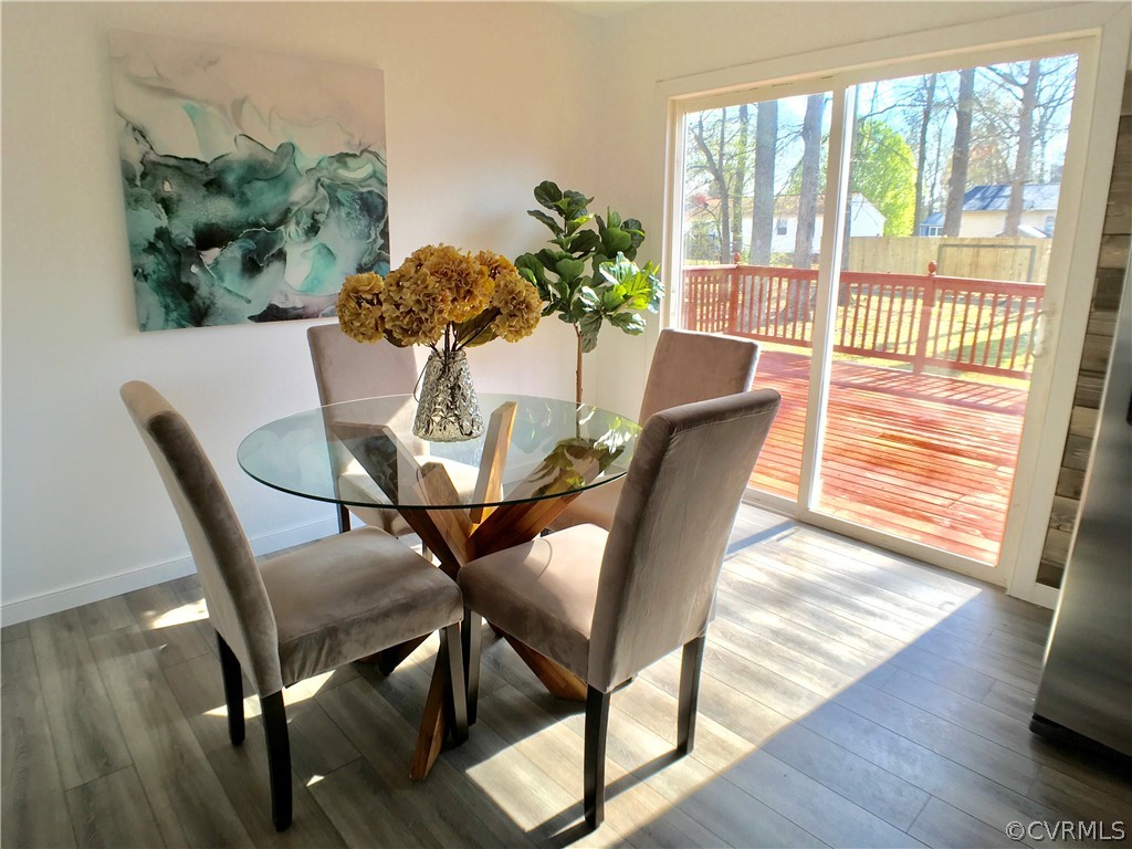 14100 South Hackberry Road Chester, VA 23836 - Photo 6 of 42 a dining room with furniture potted plants and wooden floor