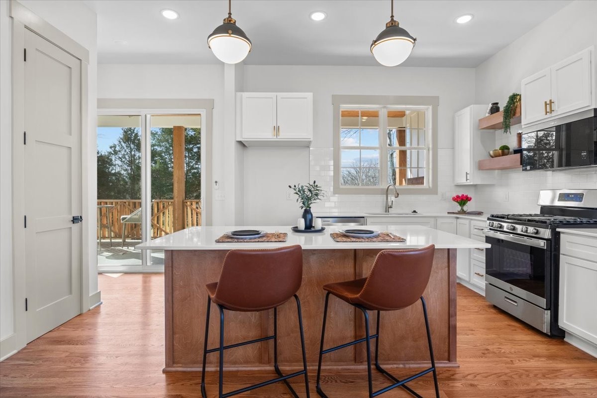 795 Jason Chapel Road Dickson, TN 37055 - Photo 12 of 35 a kitchen with stainless steel appliances granite countertop a stove a sink and a refrigerator