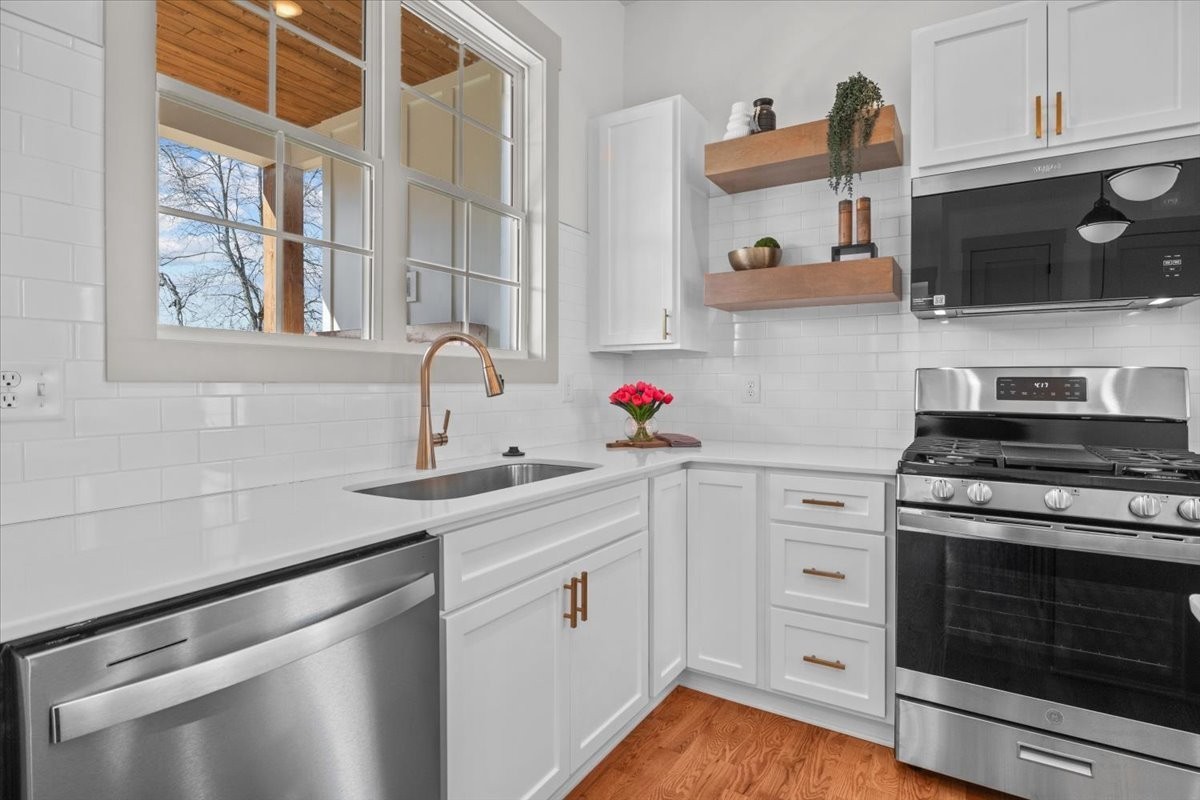 795 Jason Chapel Road Dickson, TN 37055 - Photo 15 of 35 a kitchen with stainless steel appliances white cabinets and a stove top oven