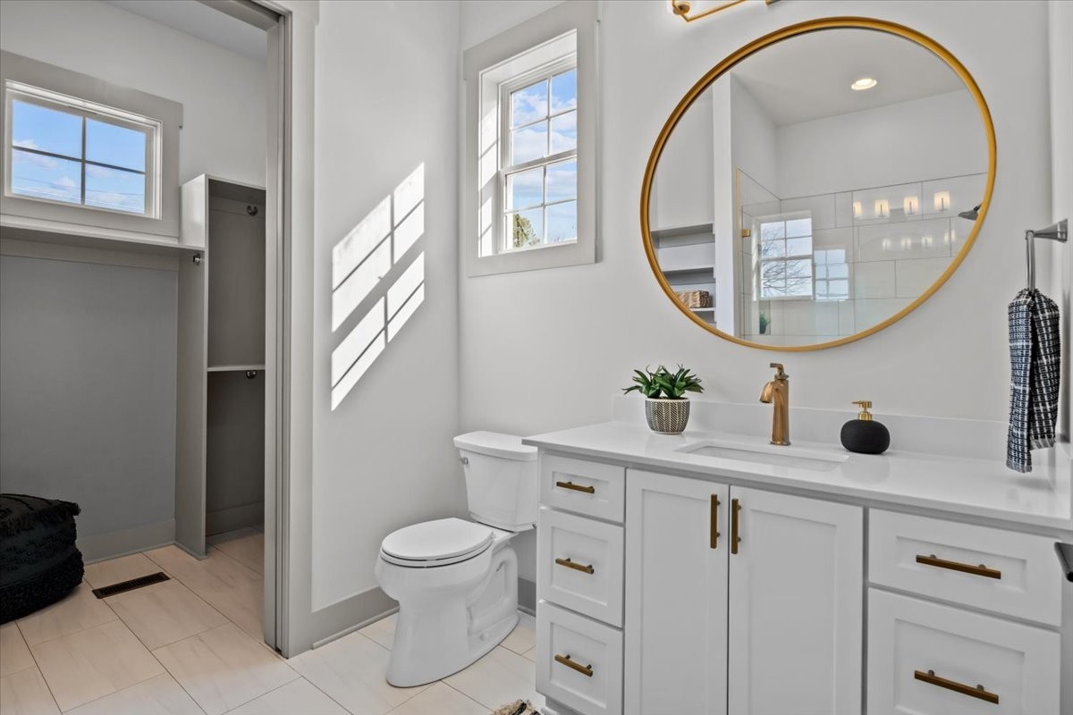 795 Jason Chapel Road Dickson, TN 37055 - Photo 25 of 35 a bathroom with a toilet a sink and a mirror