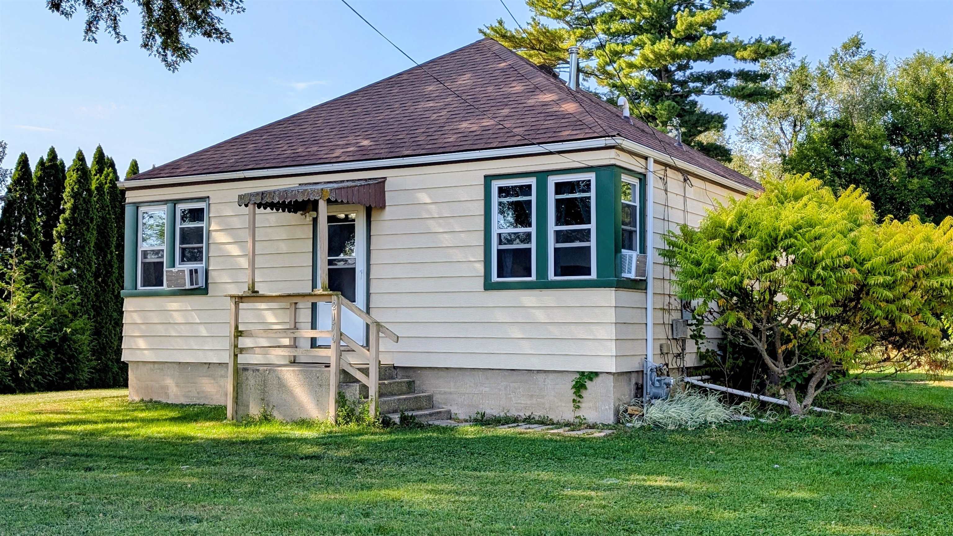 2156 North Leaf River Road Mount Morris, IL 61054 - Photo 15 of 21 a front view of a house with a garden and yard