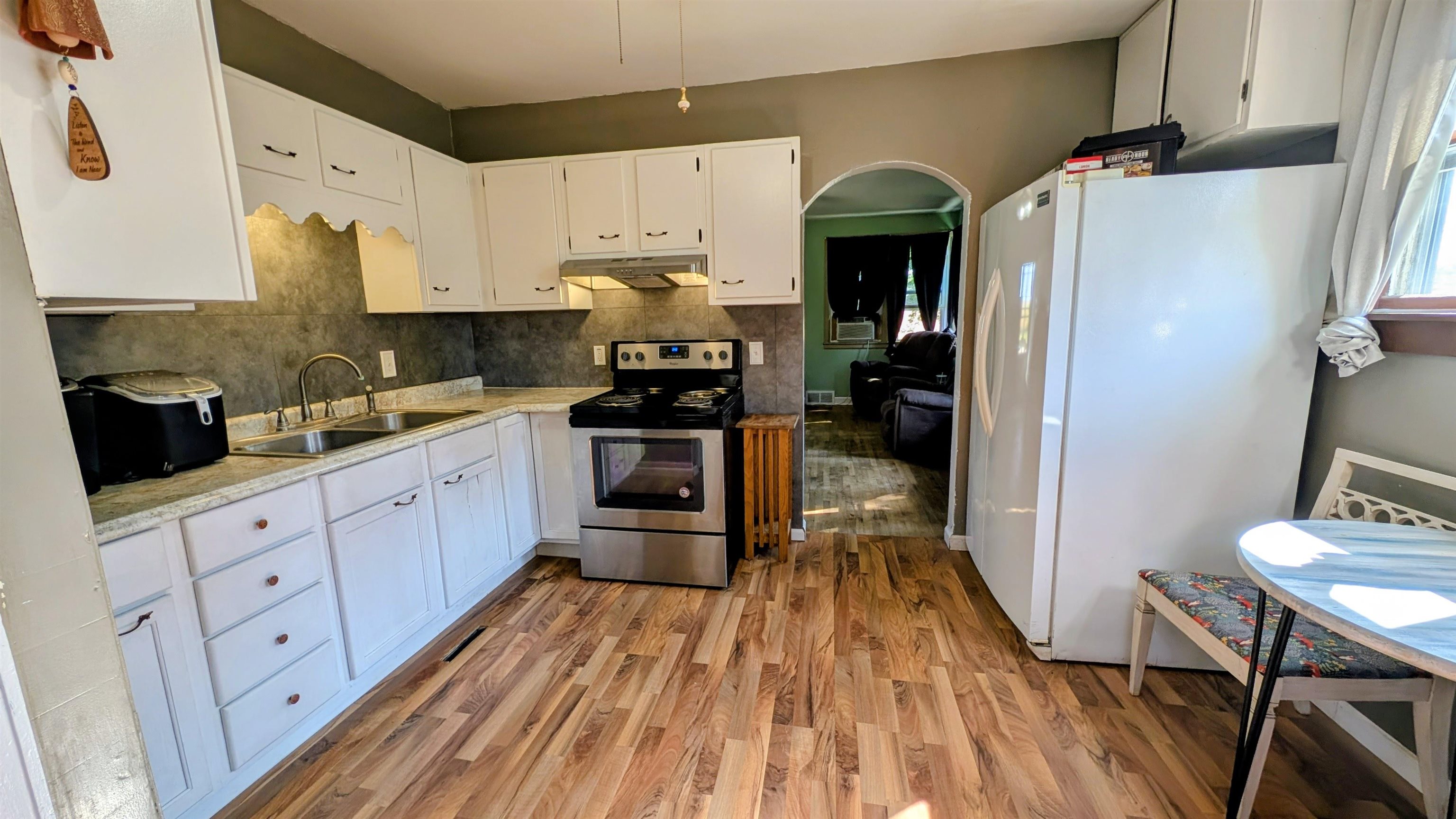 2156 North Leaf River Road Mount Morris, IL 61054 - Photo 6 of 21 a kitchen with cabinets a sink and wooden floor
