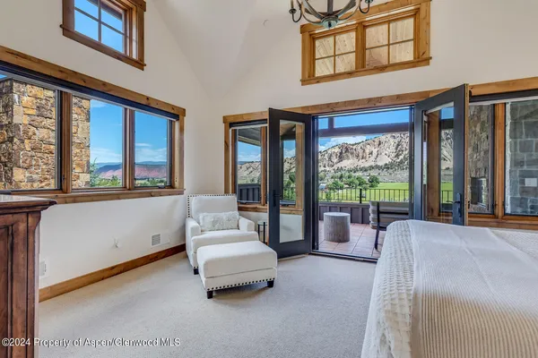 a living room with furniture and large windows