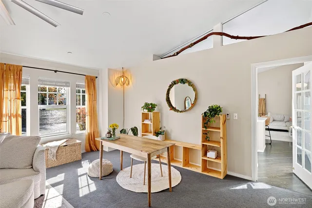 a living room with fireplace furniture and a large window