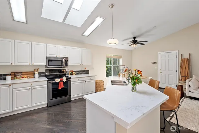a kitchen with a stove a sink and a refrigerator