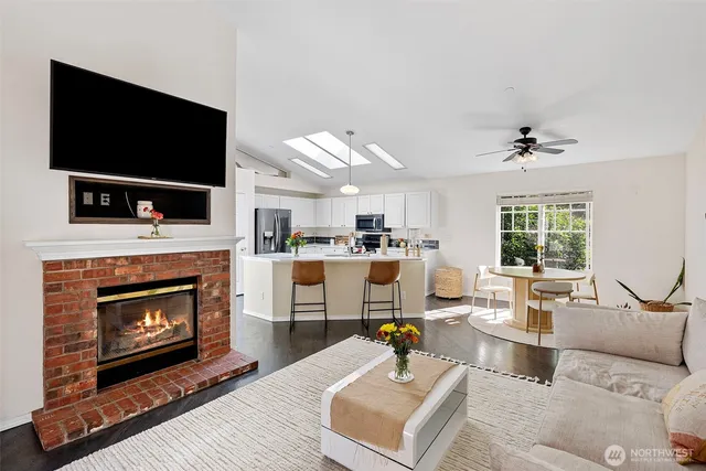 a living room with furniture a fireplace and a flat screen tv