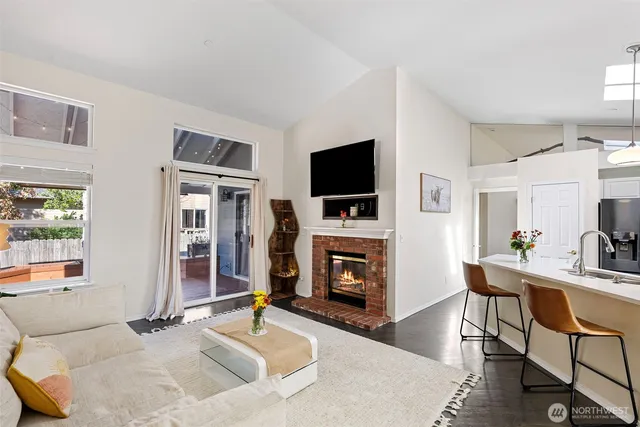 a living room with fireplace furniture and a flat screen tv
