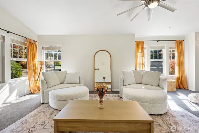 a living room with furniture fireplace and a large window