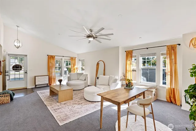 a living room with furniture a table and a large window