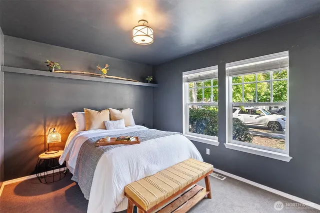 a bed sitting in a bedroom next to a window