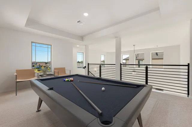 a living room with pool table