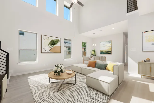 a living room with furniture a rug and a table