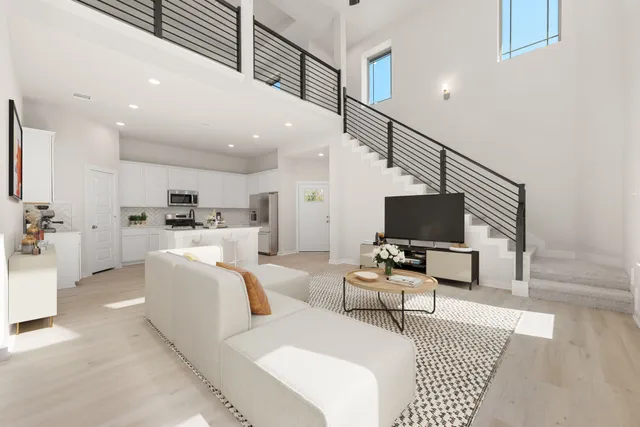 a living room with furniture kitchen view and a flat screen tv