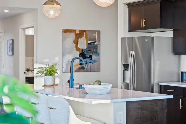 a kitchen with stainless steel appliances granite countertop a sink dishwasher and a stove with wooden floor