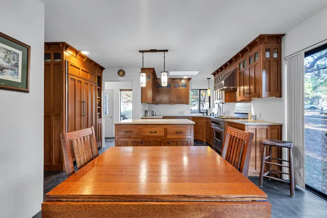 a kitchen with stainless steel appliances a stove a sink and a microwave