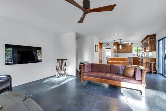 a kitchen with stainless steel appliances granite countertop a sink window and cabinets