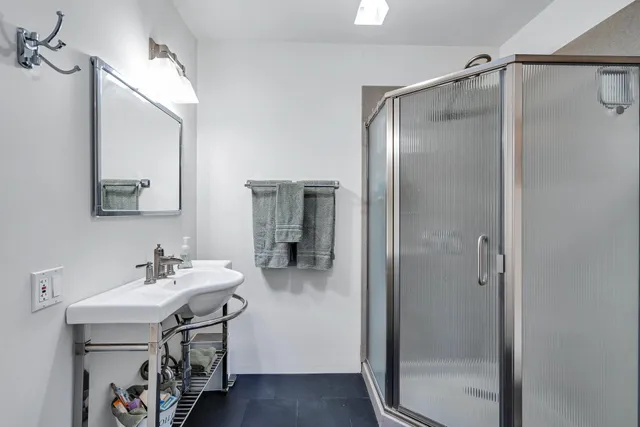 a kitchen with stainless steel appliances a white stove top oven a sink and a large window