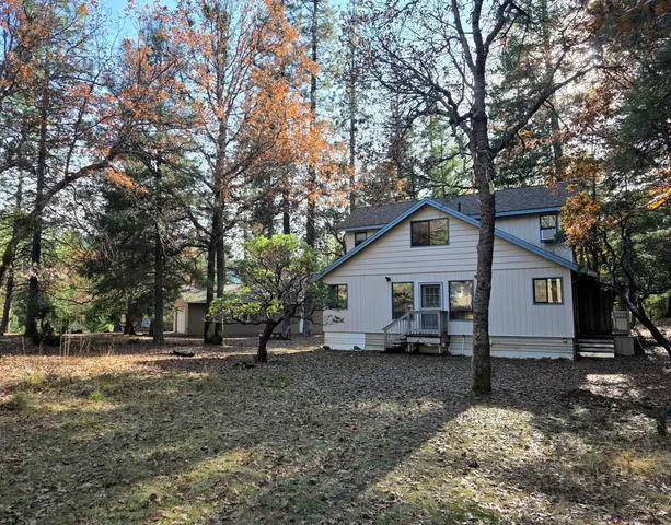 a living room with furniture a ceiling fan and a window