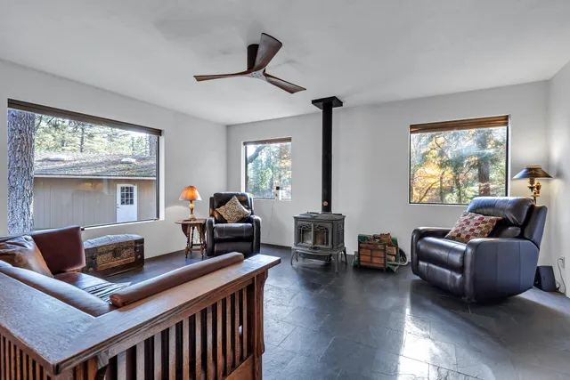 a kitchen with stainless steel appliances granite countertop a kitchen island a stove a sink a table and chairs