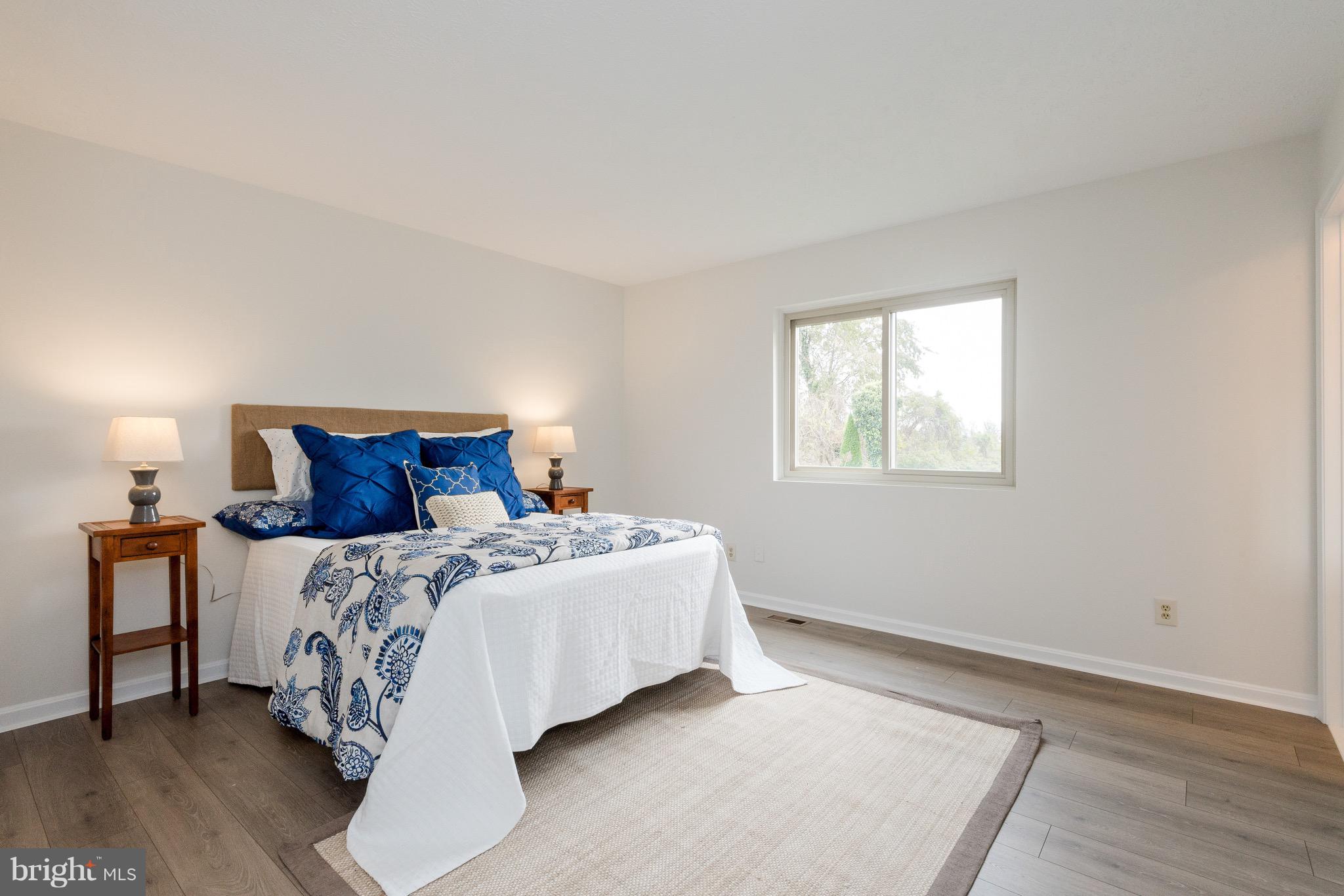 627 Truxton Road Annapolis, MD 21409 - Photo 15 of 48 a bedroom with a bed and wooden floor