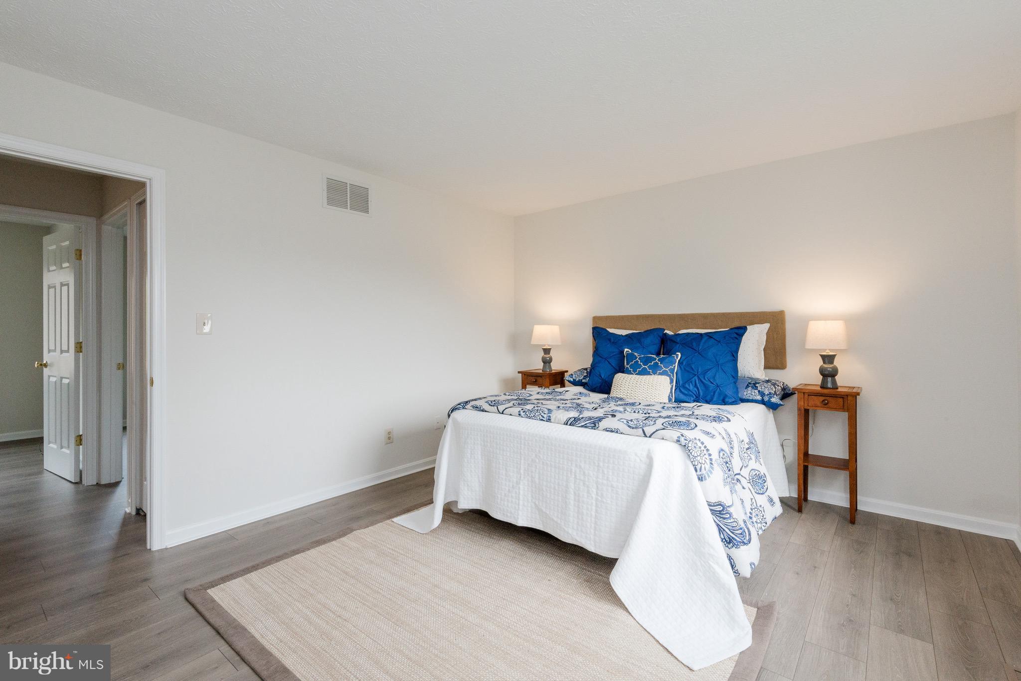 627 Truxton Road Annapolis, MD 21409 - Photo 16 of 48 a bedroom with a bed and wooden floor