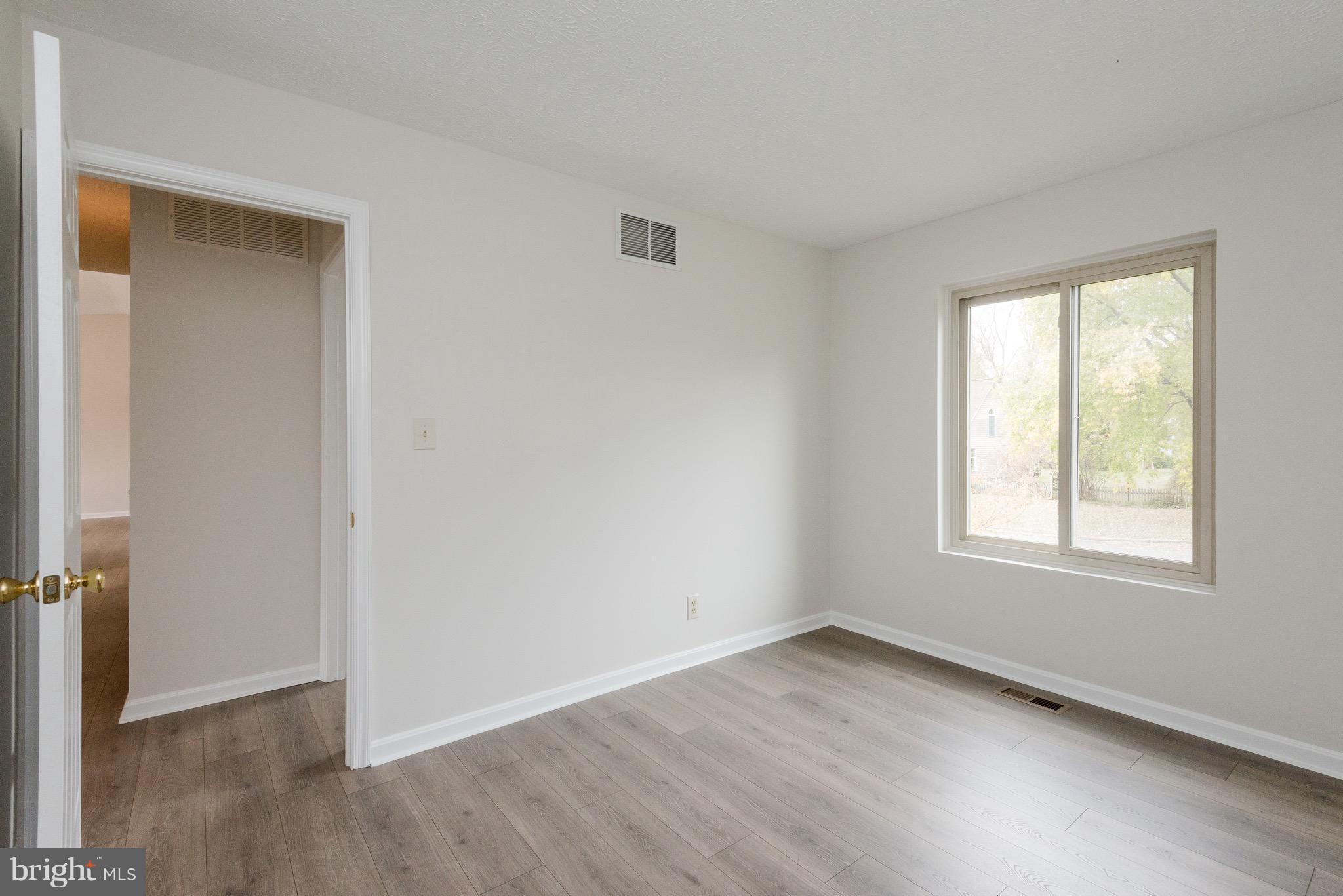 627 Truxton Road Annapolis, MD 21409 - Photo 17 of 48 an empty room with wooden floor and windows