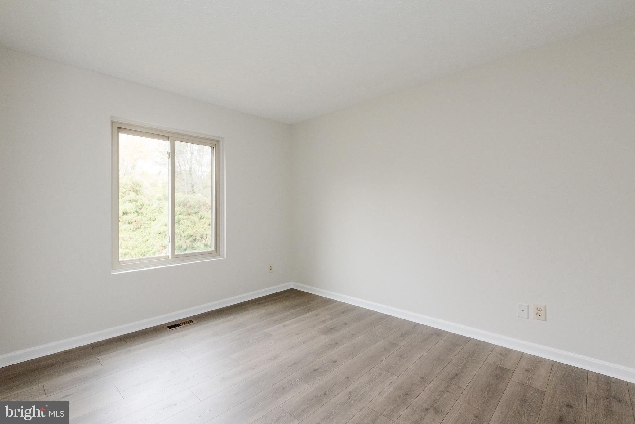 627 Truxton Road Annapolis, MD 21409 - Photo 19 of 48 an empty room with wooden floor and window