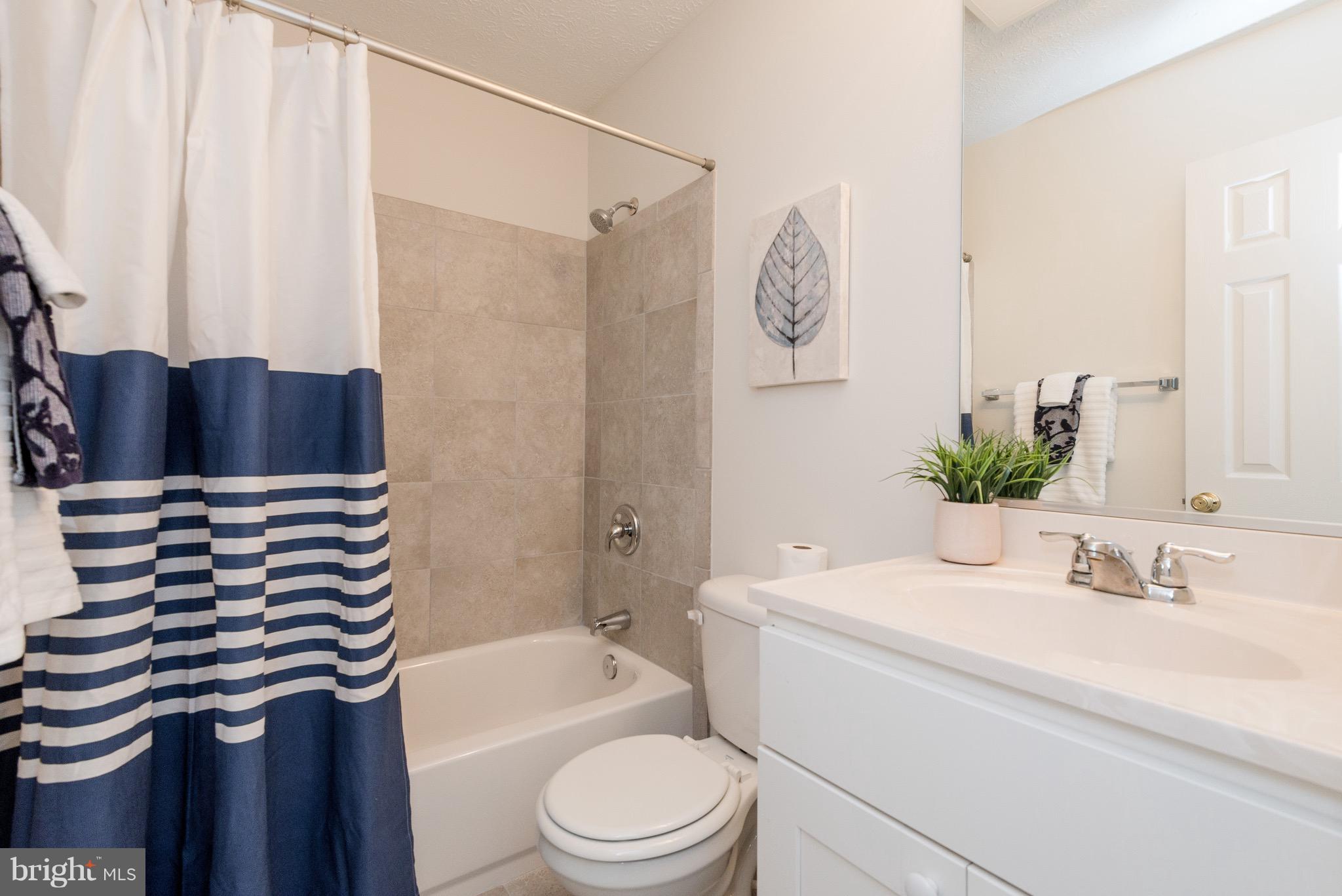 627 Truxton Road Annapolis, MD 21409 - Photo 21 of 48 a bathroom with a sink a toilet and shower