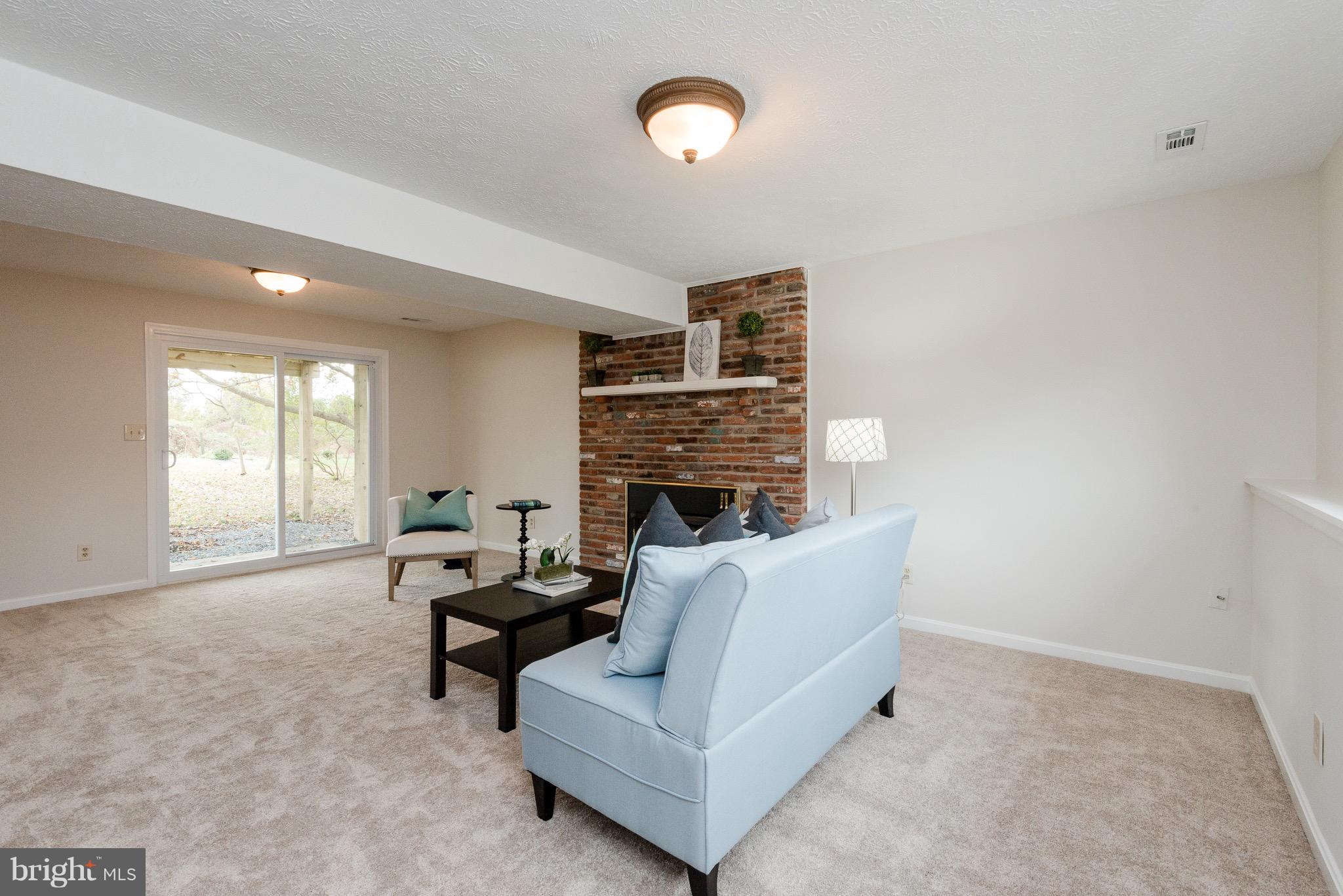 627 Truxton Road Annapolis, MD 21409 - Photo 24 of 48 a living room with furniture and a fireplace