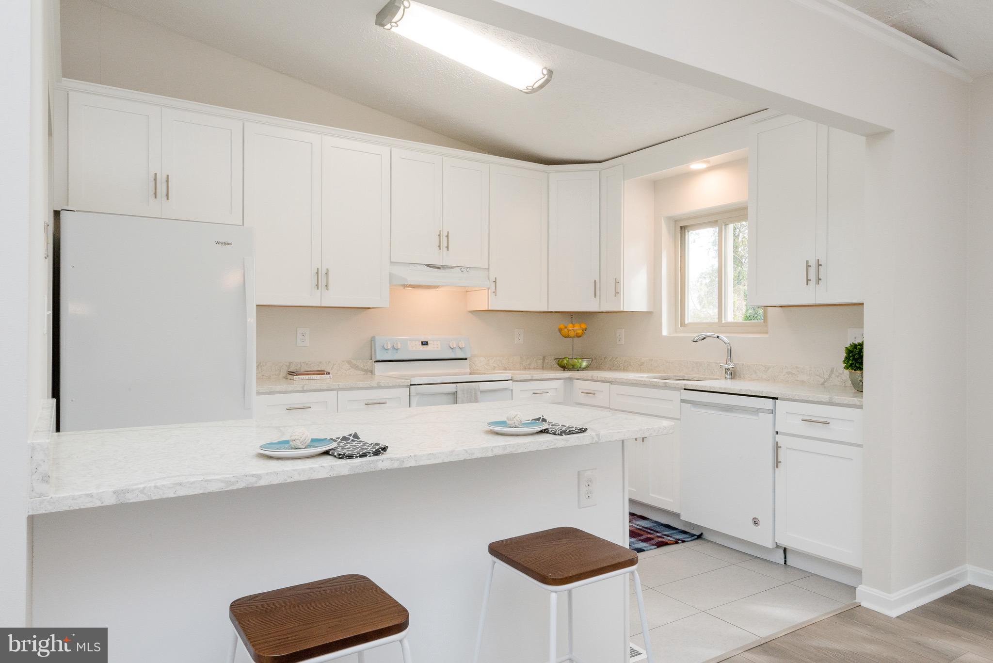 627 Truxton Road Annapolis, MD 21409 - Photo 35 of 48 a kitchen with stainless steel appliances granite countertop a sink a stove a refrigerator and white cabinets