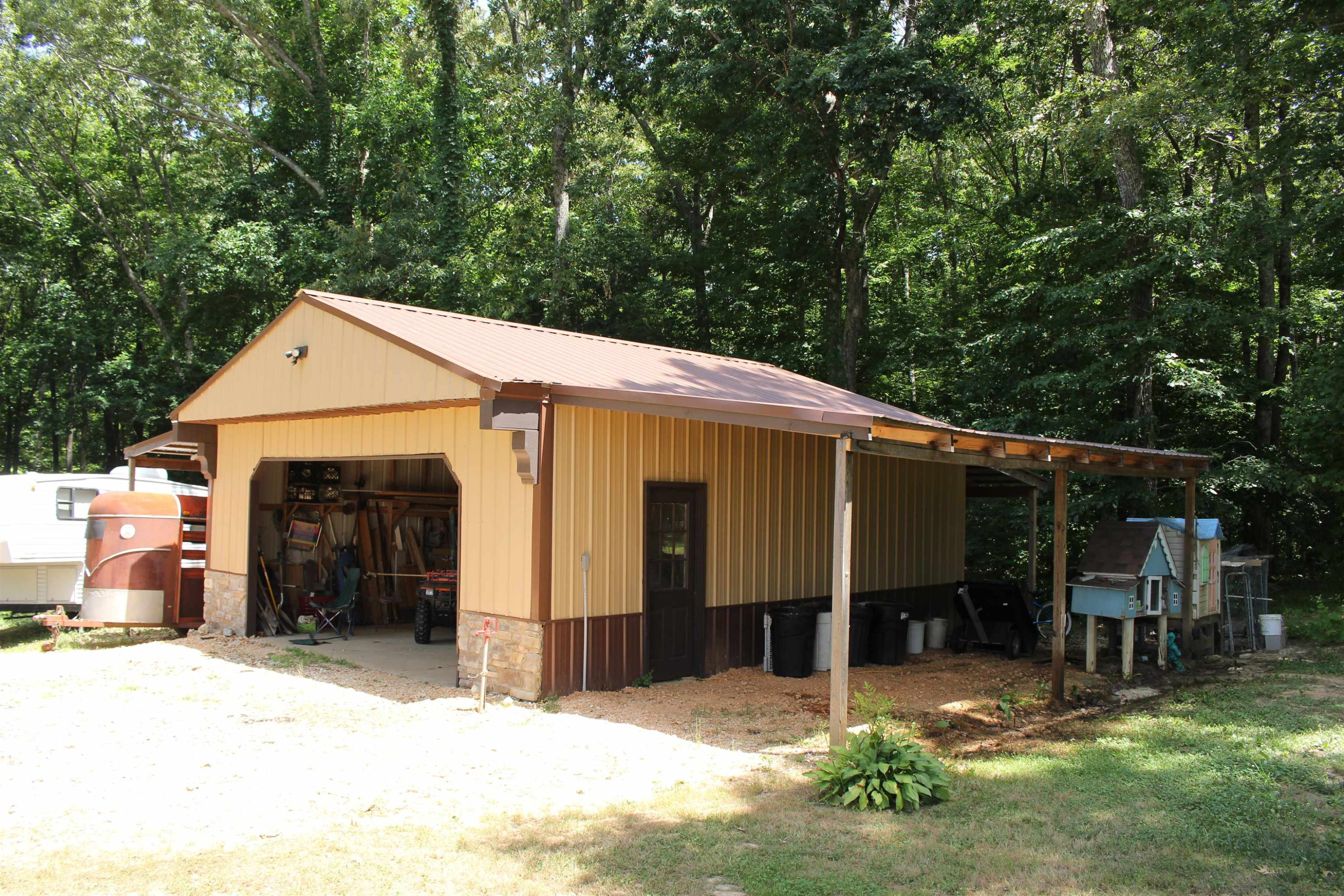 282 Cotton Grove Road Beech Bluff, TN 38313 - Photo 44 of 47 a view of a house with a yard and lawn chairs under a large tree