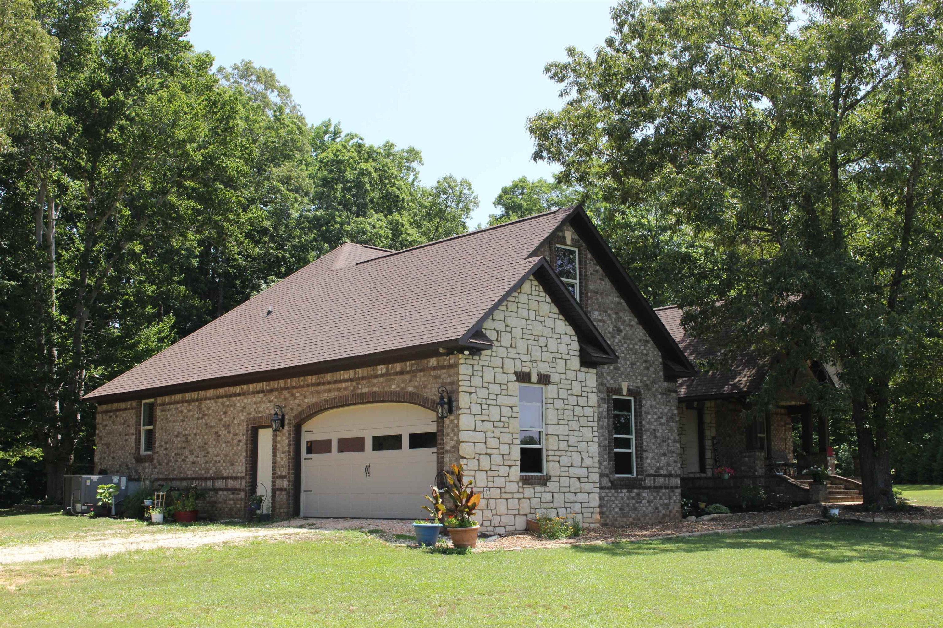 282 Cotton Grove Road Beech Bluff, TN 38313 - Photo 5 of 47 a view of a white house with a big yard and large trees