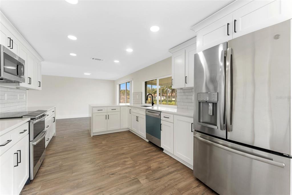 4016 Grayton Drive New Port Richey, FL 34652 - Photo 14 of 40 a kitchen with stainless steel appliances a refrigerator stove and sink