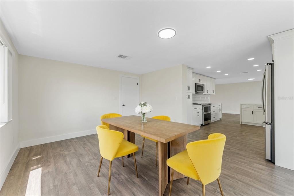 4016 Grayton Drive New Port Richey, FL 34652 - Photo 16 of 40 a view of a dining room with furniture and wooden floor