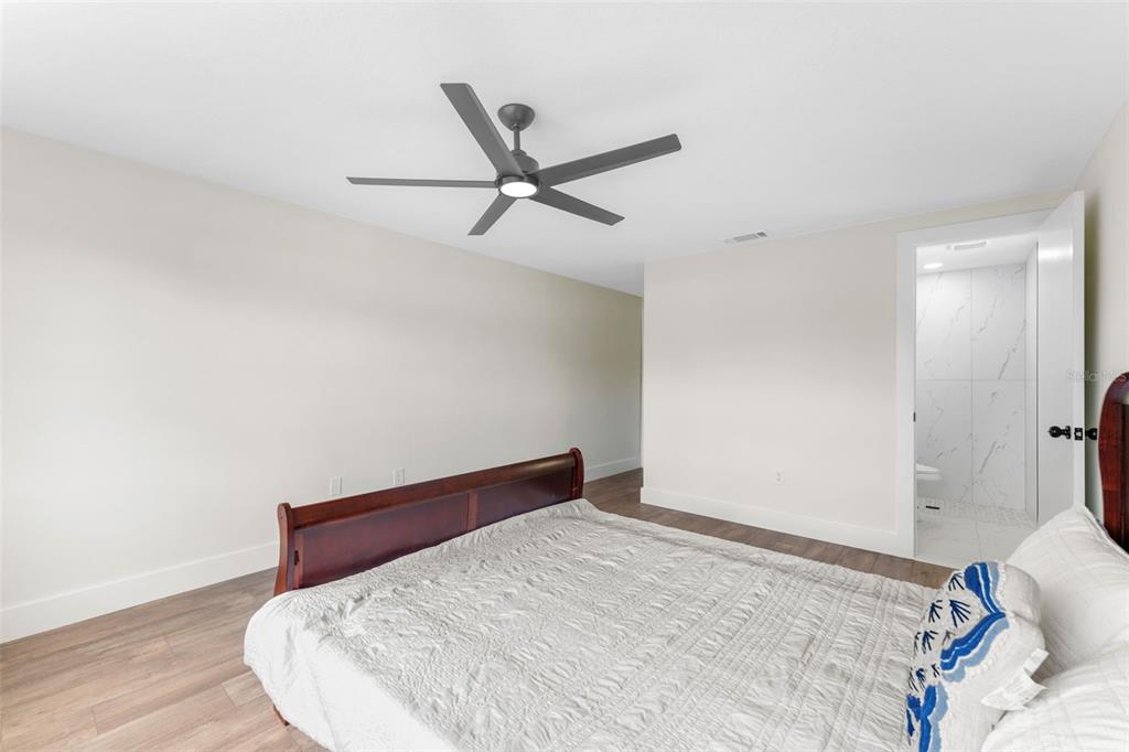 4016 Grayton Drive New Port Richey, FL 34652 - Photo 18 of 40 a bedroom with a bed and a ceiling fan